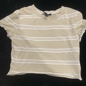 A cropped beige and white shirt